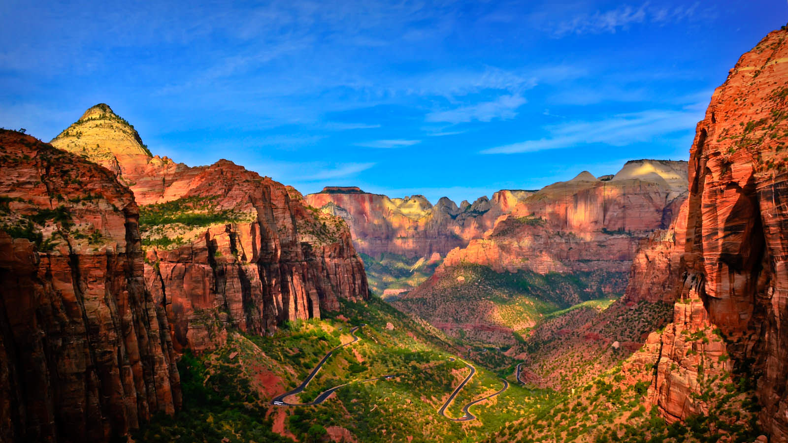 A scenic view of a mountain valley with a winding road
